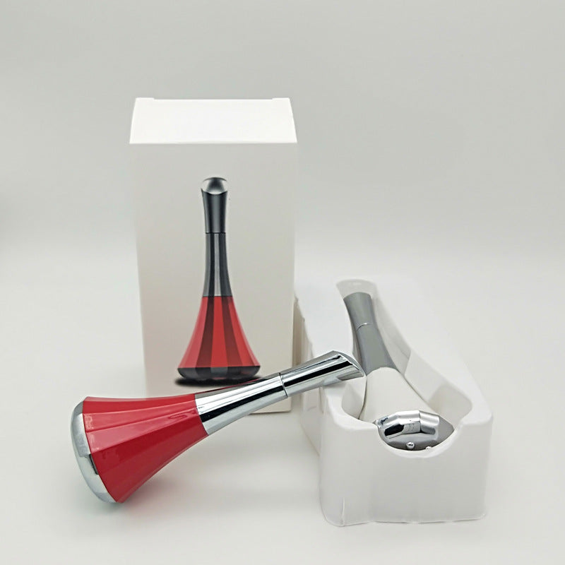 Woman using facial massager for tighter skin at home