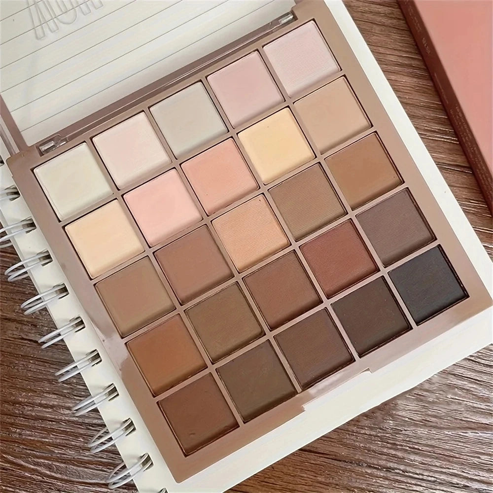 Makeup palette with various neutral shades on a wooden surface